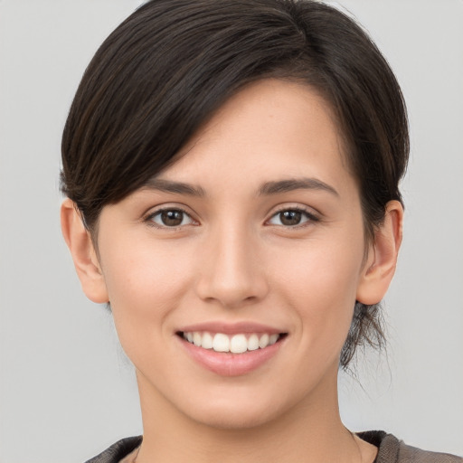 Joyful white young-adult female with medium  brown hair and brown eyes