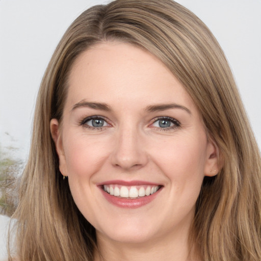 Joyful white young-adult female with long  brown hair and grey eyes