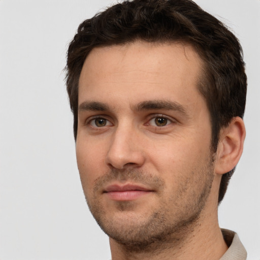 Joyful white young-adult male with short  brown hair and brown eyes