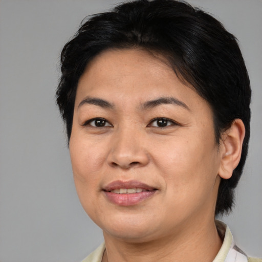 Joyful asian adult female with medium  brown hair and brown eyes