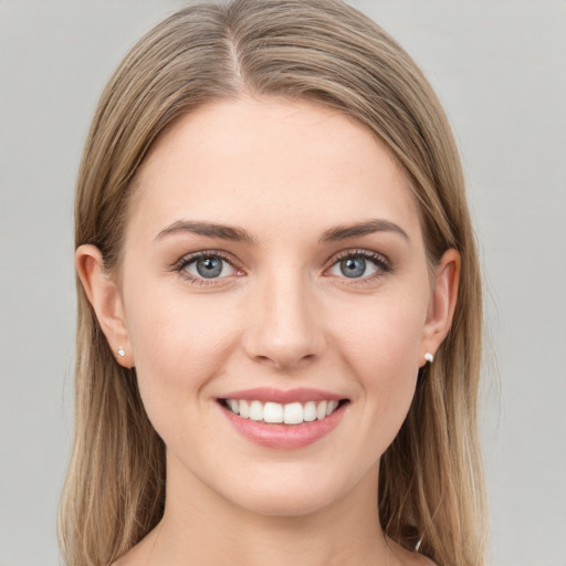 Joyful white young-adult female with long  brown hair and green eyes