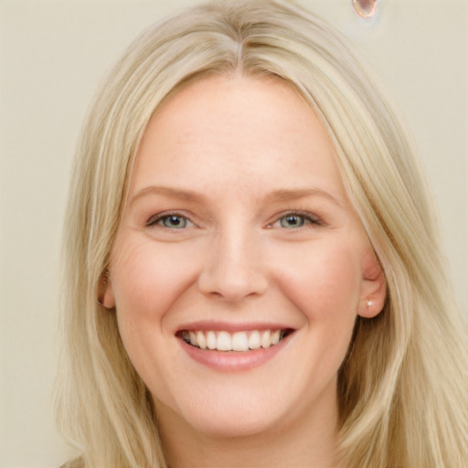 Joyful white young-adult female with long  blond hair and blue eyes