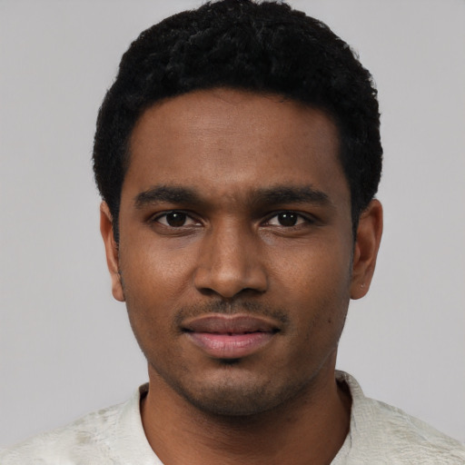 Joyful black young-adult male with short  black hair and brown eyes