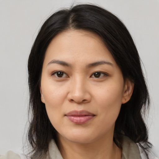 Joyful asian young-adult female with medium  brown hair and brown eyes