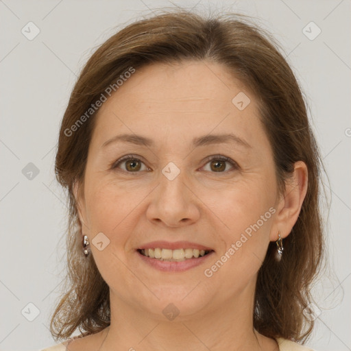 Joyful white adult female with medium  brown hair and brown eyes