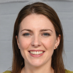 Joyful white young-adult female with medium  brown hair and grey eyes