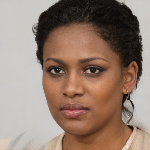 Neutral black young-adult female with medium  brown hair and brown eyes