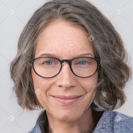 Joyful white adult female with medium  brown hair and blue eyes