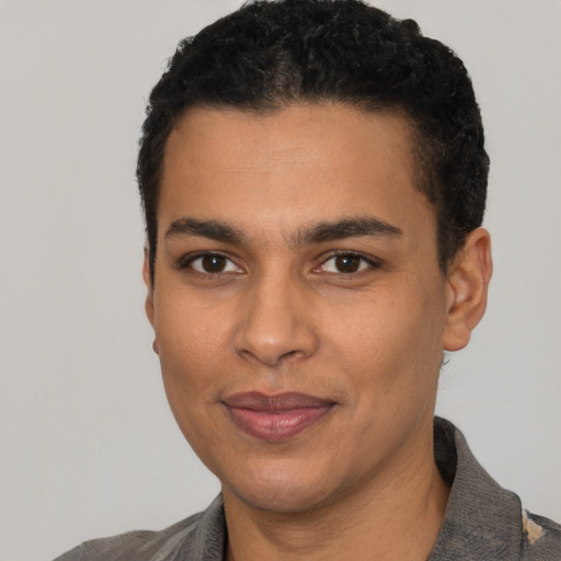 Joyful latino young-adult male with short  black hair and brown eyes