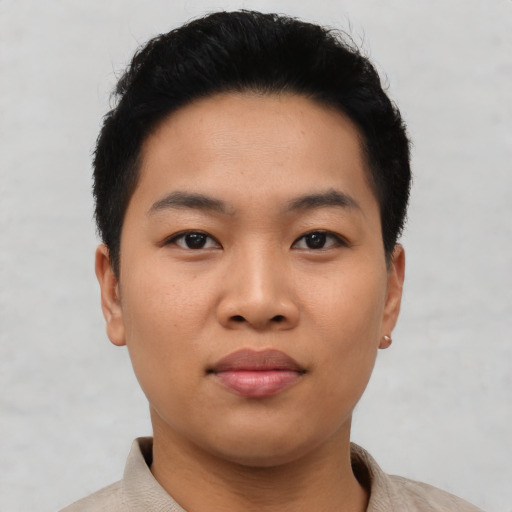 Joyful asian young-adult male with short  black hair and brown eyes