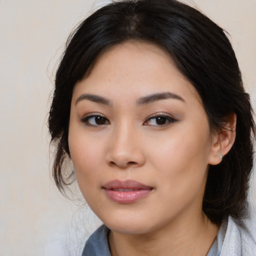 Joyful latino young-adult female with medium  black hair and brown eyes