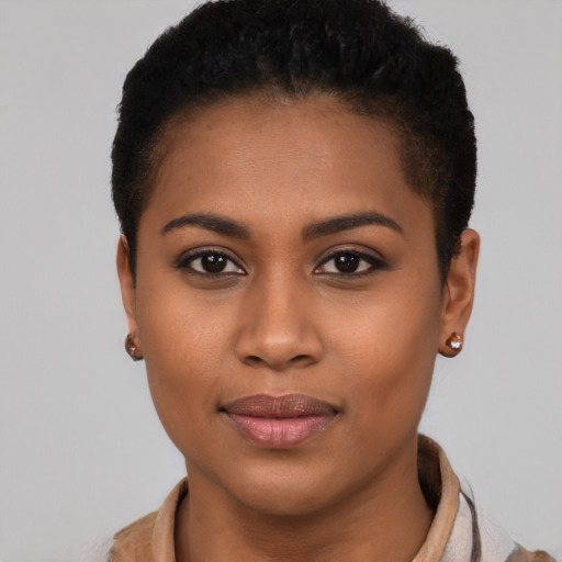 Joyful black young-adult female with short  black hair and brown eyes
