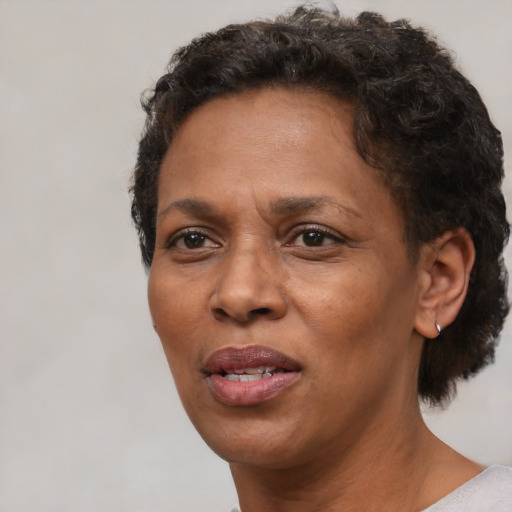Joyful black adult female with short  brown hair and brown eyes