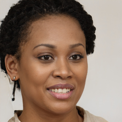 Joyful black young-adult female with short  brown hair and brown eyes