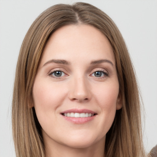 Joyful white young-adult female with long  brown hair and grey eyes