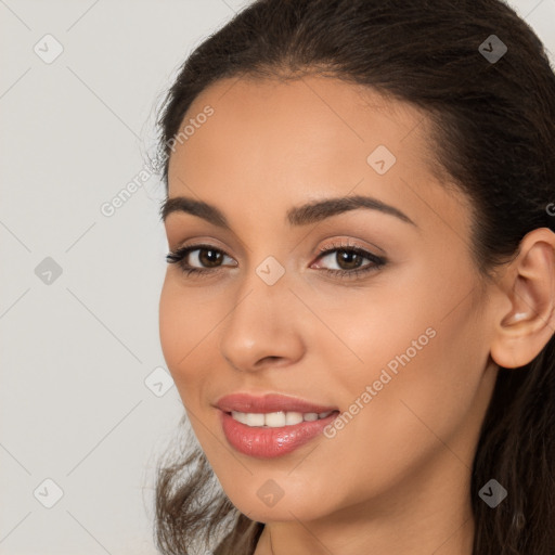 Joyful latino young-adult female with long  brown hair and brown eyes