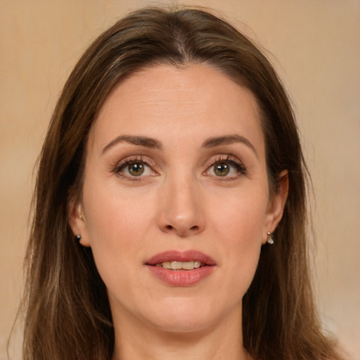 Joyful white young-adult female with long  brown hair and green eyes