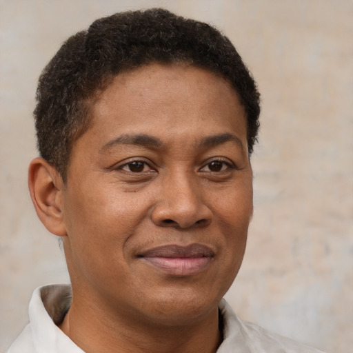 Joyful black young-adult male with short  brown hair and brown eyes