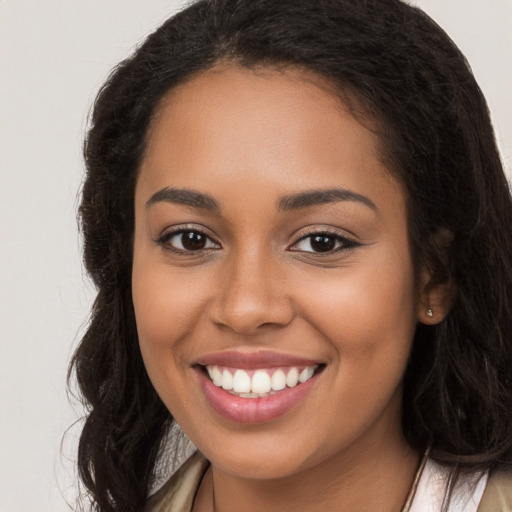 Joyful latino young-adult female with long  brown hair and brown eyes