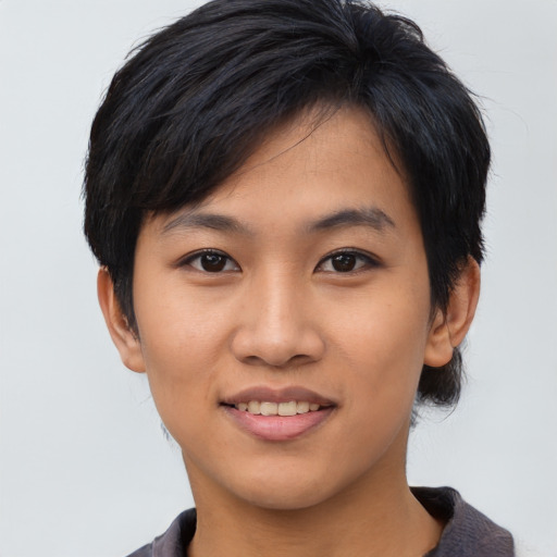 Joyful asian young-adult female with short  black hair and brown eyes