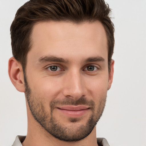 Joyful white young-adult male with short  brown hair and brown eyes