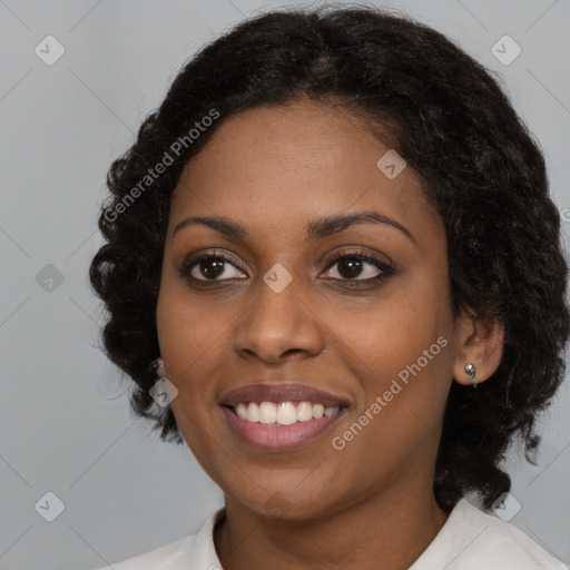 Joyful black young-adult female with medium  black hair and brown eyes