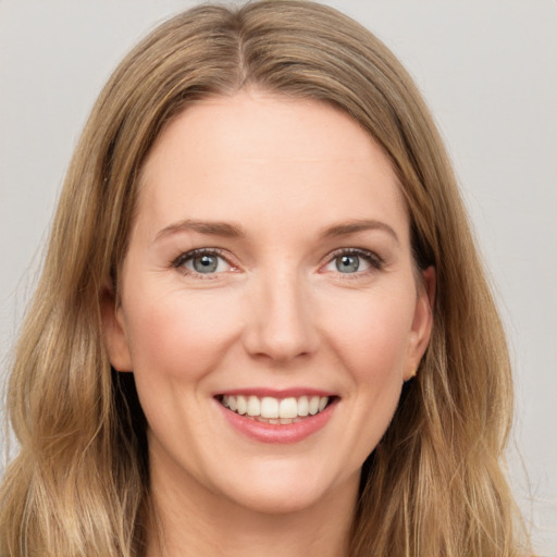 Joyful white young-adult female with long  brown hair and green eyes