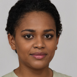 Joyful black young-adult female with short  brown hair and brown eyes