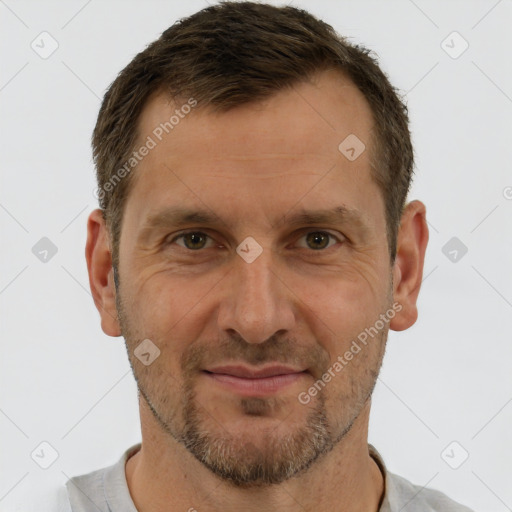 Joyful white adult male with short  brown hair and brown eyes