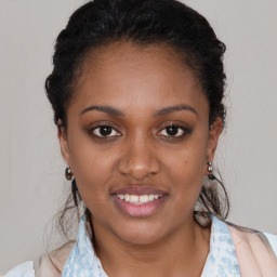 Joyful black young-adult female with medium  brown hair and brown eyes