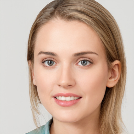 Joyful white young-adult female with long  brown hair and grey eyes