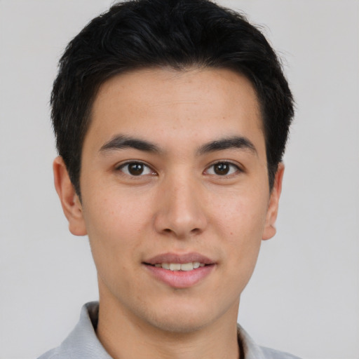 Joyful asian young-adult male with short  brown hair and brown eyes