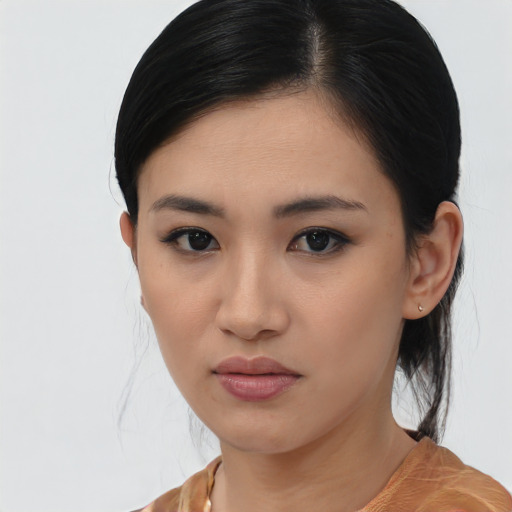 Joyful asian young-adult female with medium  black hair and brown eyes