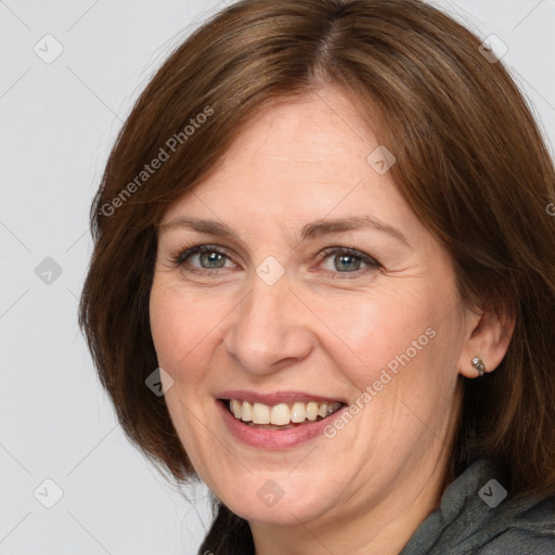 Joyful white adult female with medium  brown hair and grey eyes