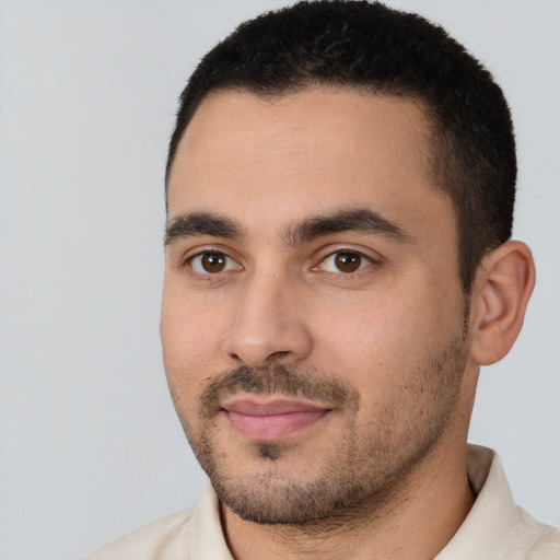 Joyful white young-adult male with short  black hair and brown eyes