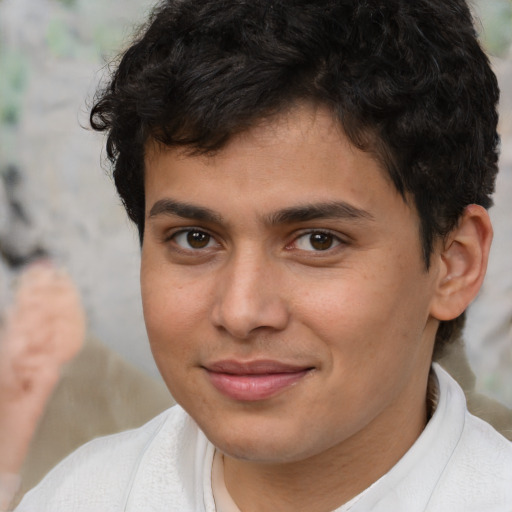 Joyful latino young-adult male with short  brown hair and brown eyes