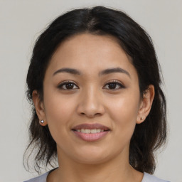 Joyful latino young-adult female with medium  brown hair and brown eyes