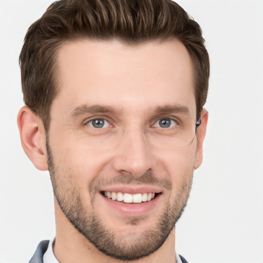 Joyful white young-adult male with short  brown hair and grey eyes