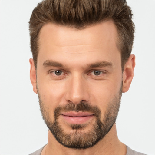 Joyful white young-adult male with short  brown hair and brown eyes