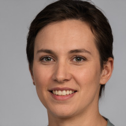 Joyful white young-adult female with medium  brown hair and brown eyes