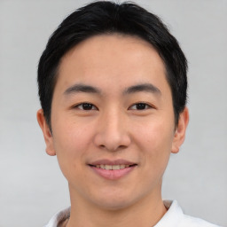 Joyful asian young-adult male with short  brown hair and brown eyes