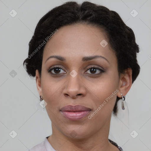 Joyful black adult female with short  brown hair and brown eyes