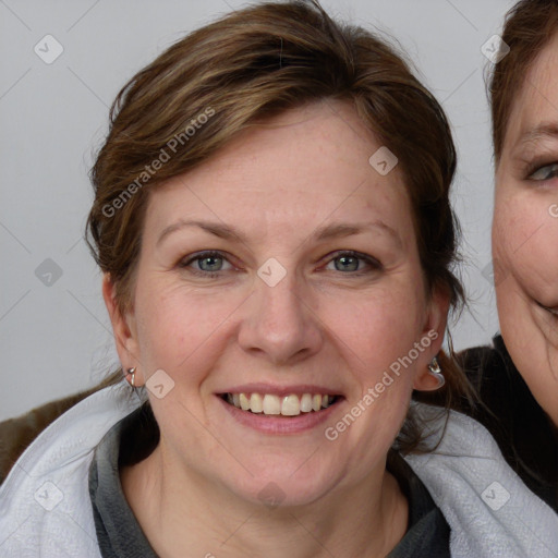 Joyful white young-adult female with medium  brown hair and blue eyes