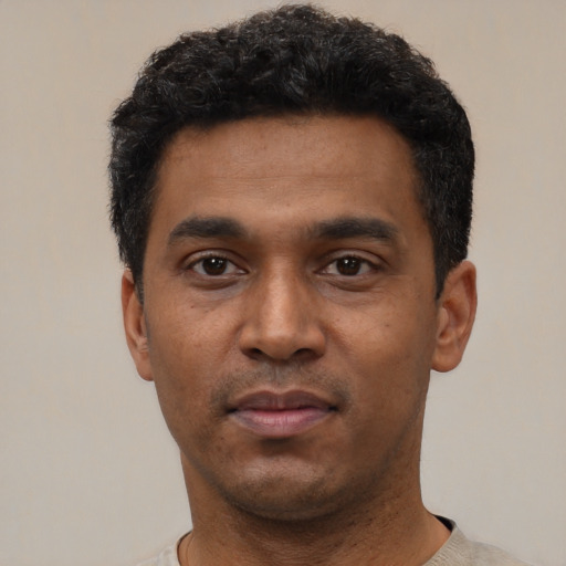 Neutral black young-adult male with short  black hair and brown eyes