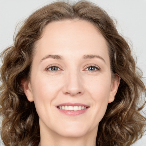 Joyful white young-adult female with medium  brown hair and green eyes