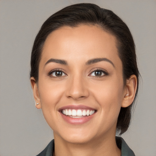 Joyful white young-adult female with medium  brown hair and brown eyes