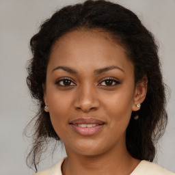 Joyful black young-adult female with medium  brown hair and brown eyes