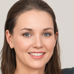 Joyful white young-adult female with long  brown hair and grey eyes