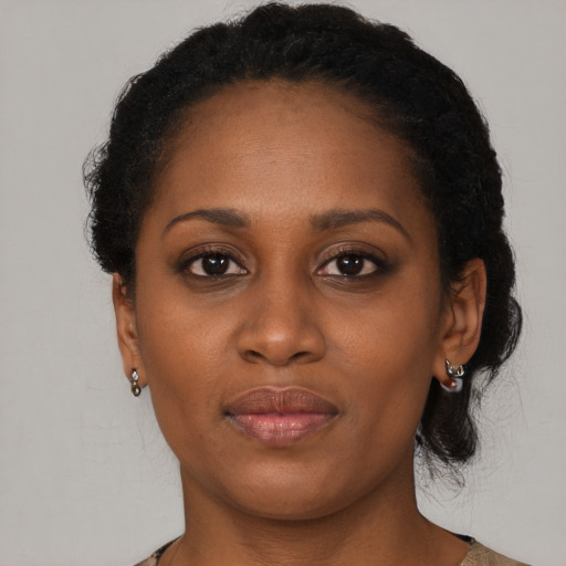 Joyful black young-adult female with short  brown hair and brown eyes