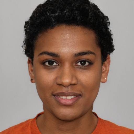 Joyful black young-adult female with short  black hair and brown eyes